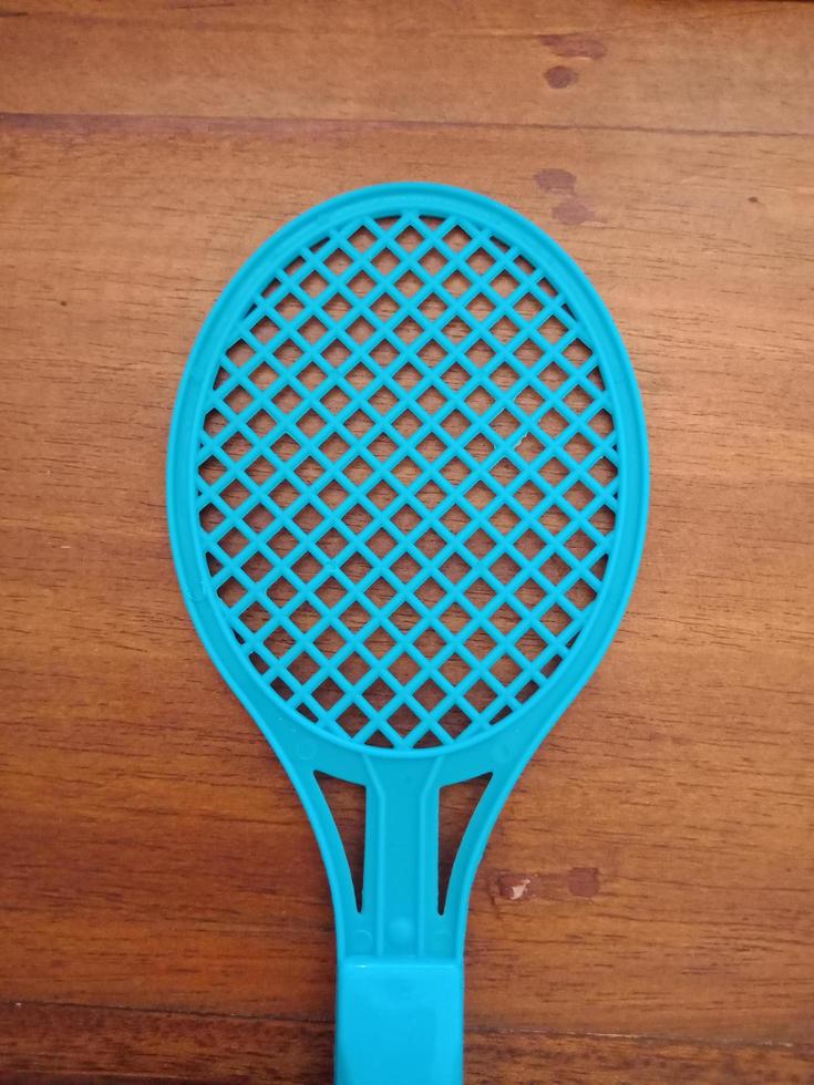 Top view portrait racket toy on wooden table photo