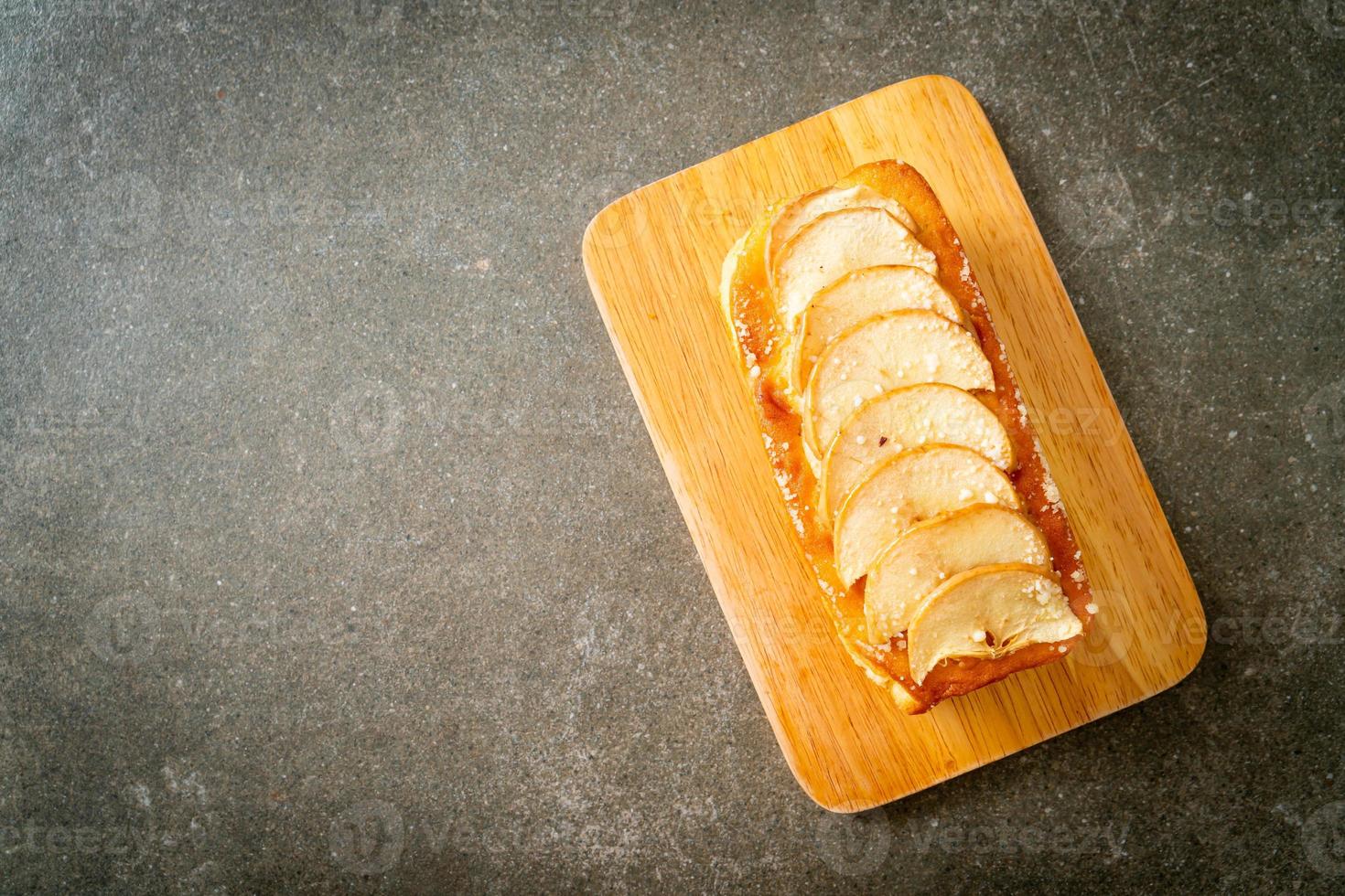 Pan de manzana desmenuzado sobre tablero de madera foto