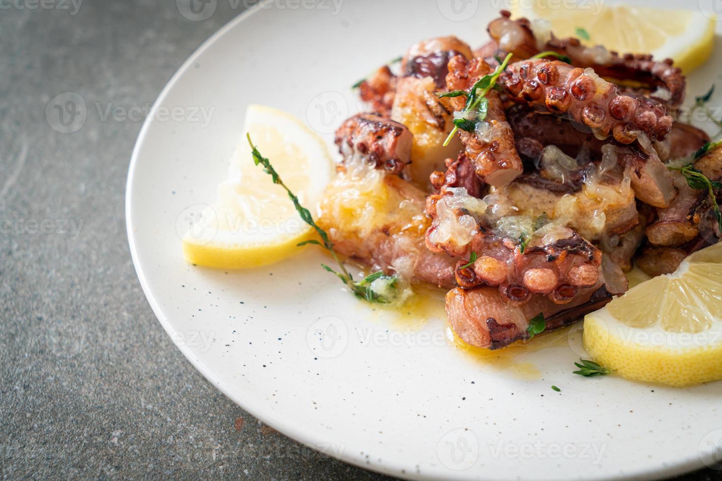 grilled octopus or squid with butter lemon sauce photo