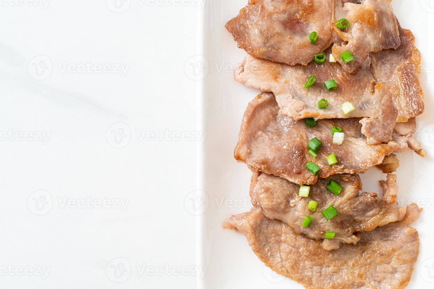 grilled pork neck sliced on plate photo
