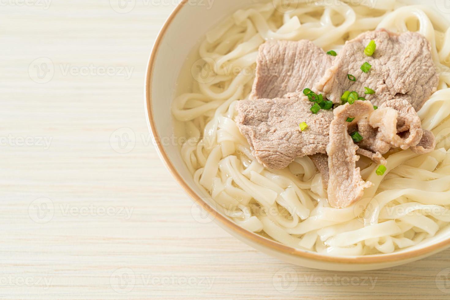 udon noodles with pork in clear soup photo