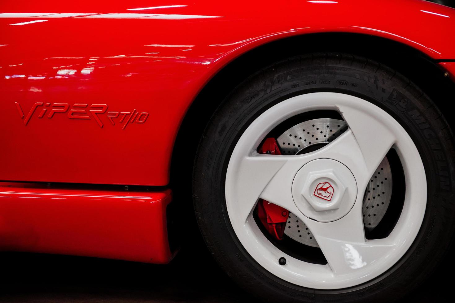 SINSHEIM, GERMANY - OCTOBER 16, 2018 Technik Museum. Close up photo of red sport car. Right side and wheel