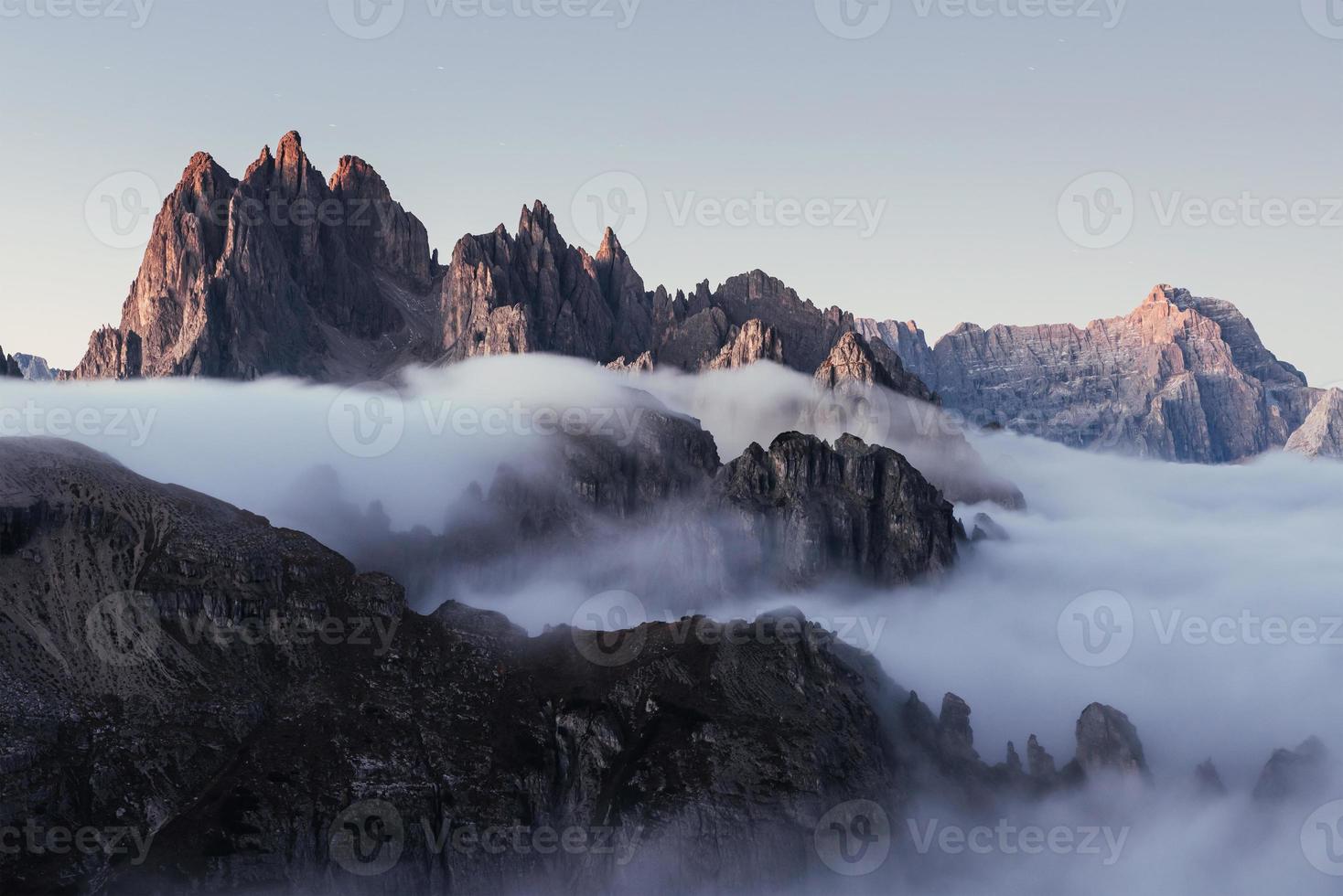 Dreamy hills on the daylight gets filled with hard mist from the under ground photo