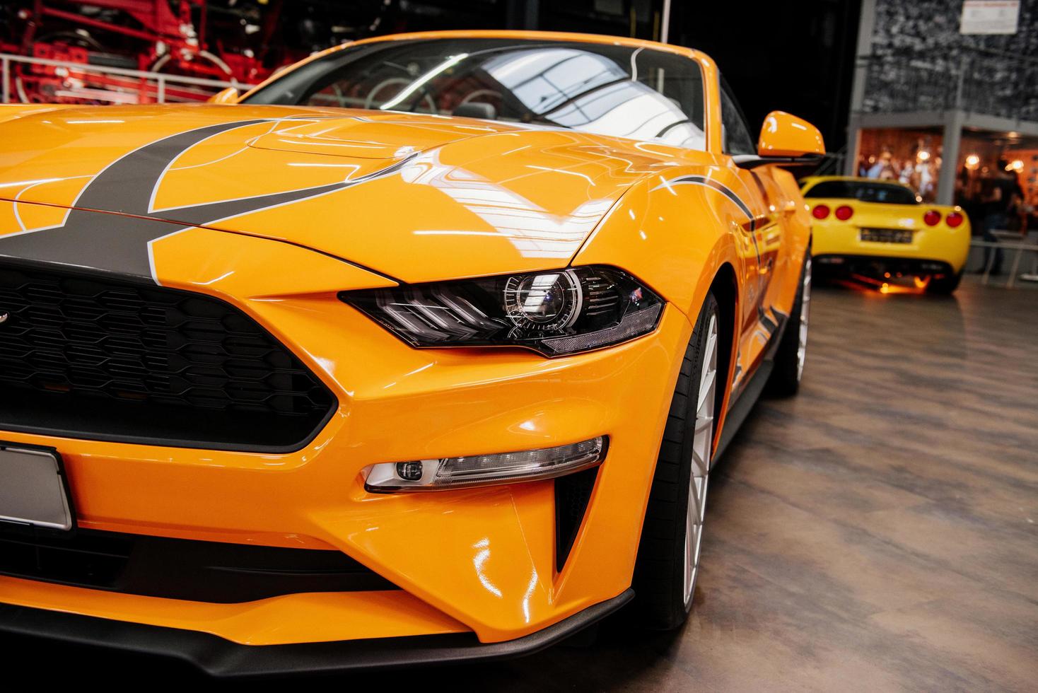 SINSHEIM, GERMANY - OCTOBER 16, 2018 Technik Museum. Two cars. Gorgeous close up view of the front of luxury yellow automobile standing indoors photo