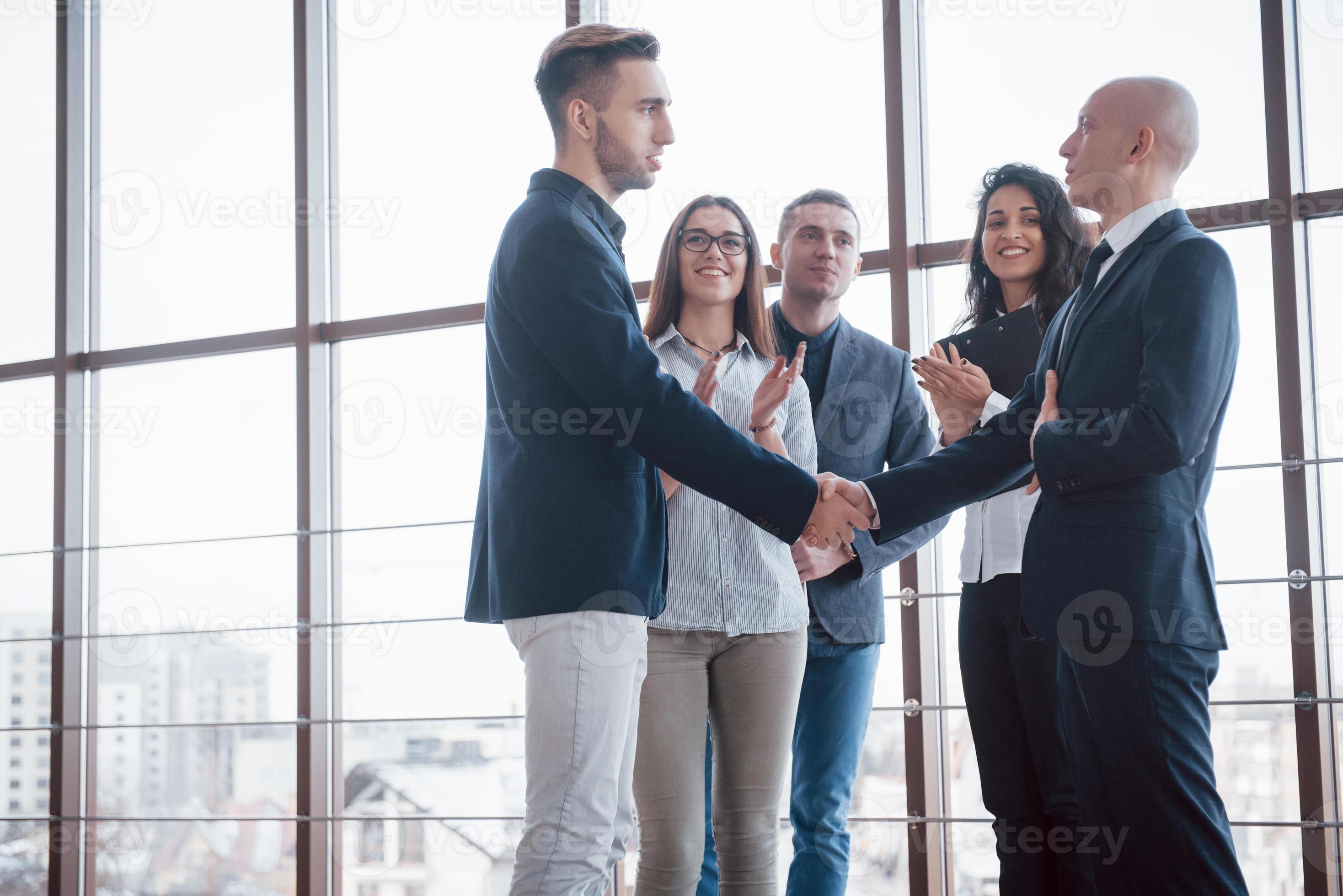 Two confident business man shaking hands during a meeting in the office, greeting and partner concept photo