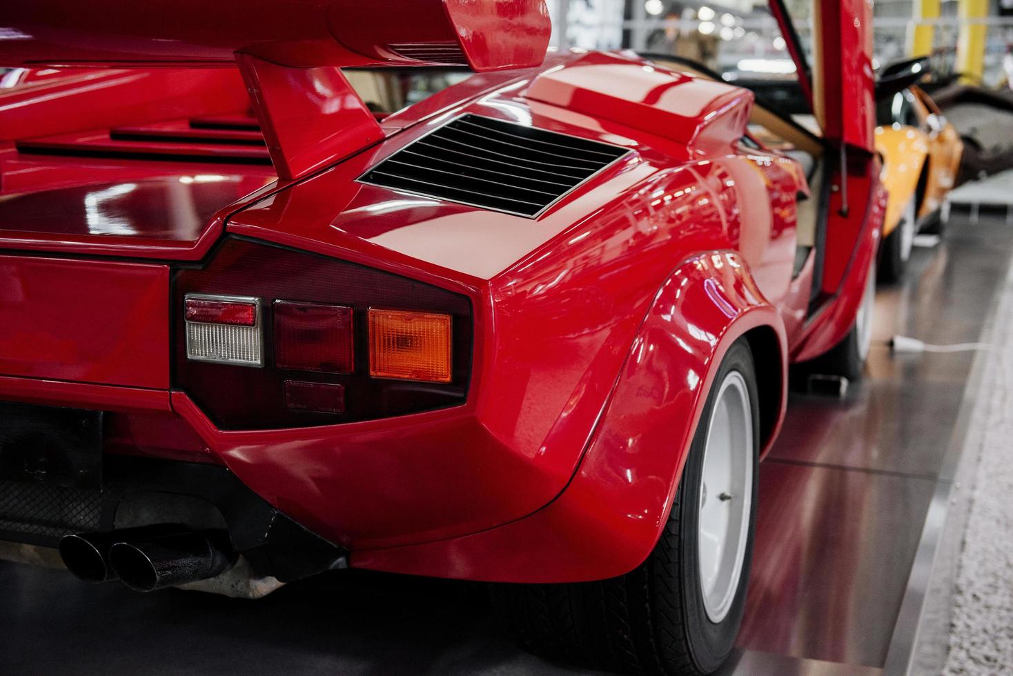 SINSHEIM, GERMANY - OCTOBER 16, 2018 Technik Museum. Back of modern luxury red car parked indoors at exhibition photo