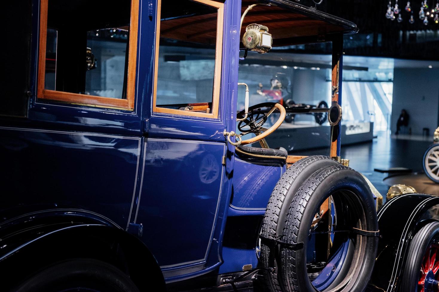 STUTTGART, GERMANY - OCTOBER 16, 2018 Mercedes Museum. Classic blue old vehicle. Side view. Spare wheels on the side photo