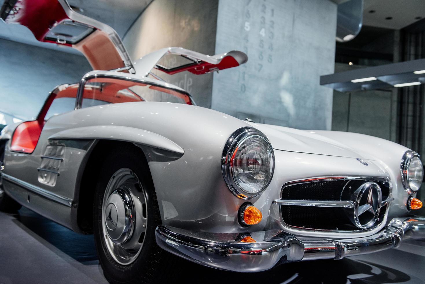 STUTTGART, GERMANY - OCTOBER 16, 2018 Mercedes Museum. Historical automobile. White retro vehicle with red salon and opened doors standing at car show photo