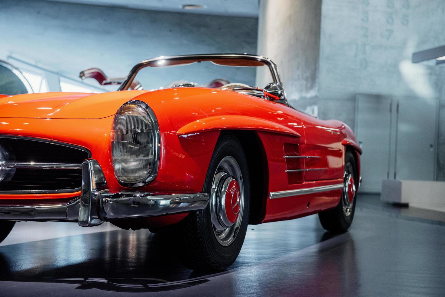 STUTTGART, GERMANY - OCTOBER 16, 2018 Mercedes Museum. Big room. Beautiful orange colored retro car captured from the front photo