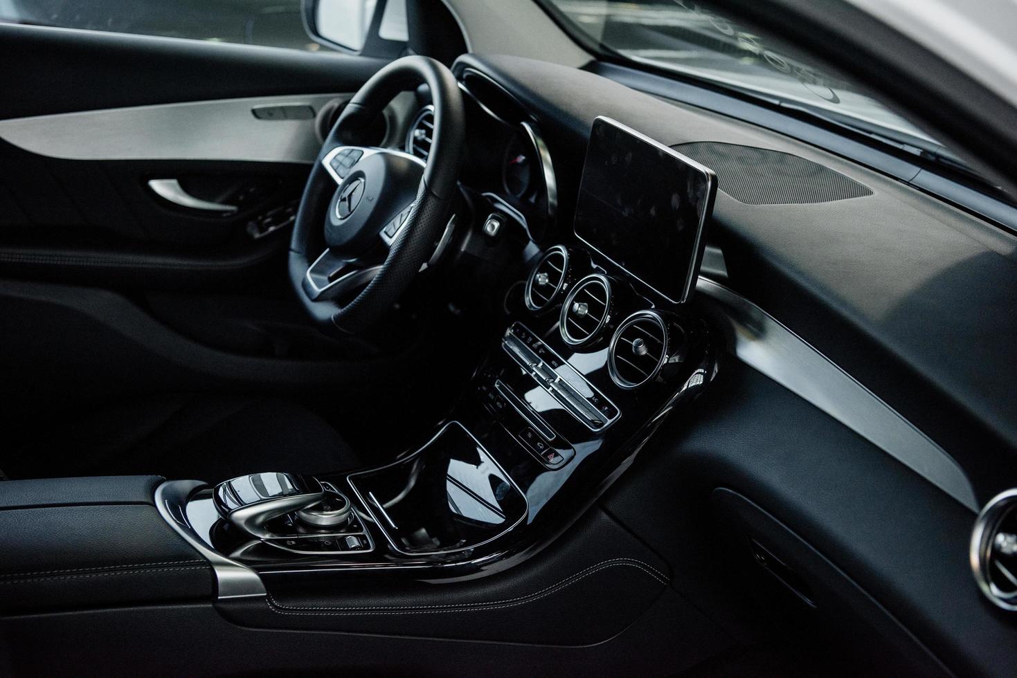 STUTTGART, GERMANY - OCTOBER 16, 2018 Mercedes Museum. Daylight is reflected from glossy parts. Inside of brand new car with black interior photo