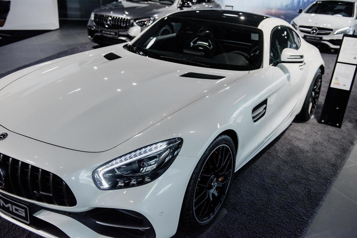 STUTTGART, GERMANY - OCTOBER 16, 2018 Mercedes Museum. Elegant look. Three new luxury cars with different colors stands indoors in auto show photo