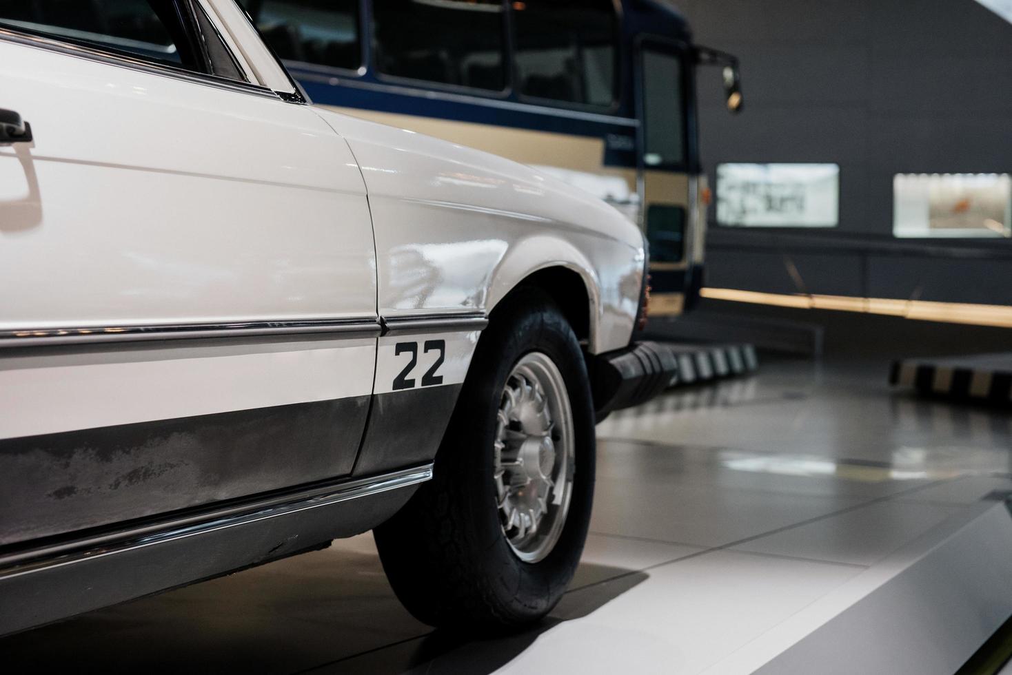Cropped image of white classic rare car parked indoor on the tile photo