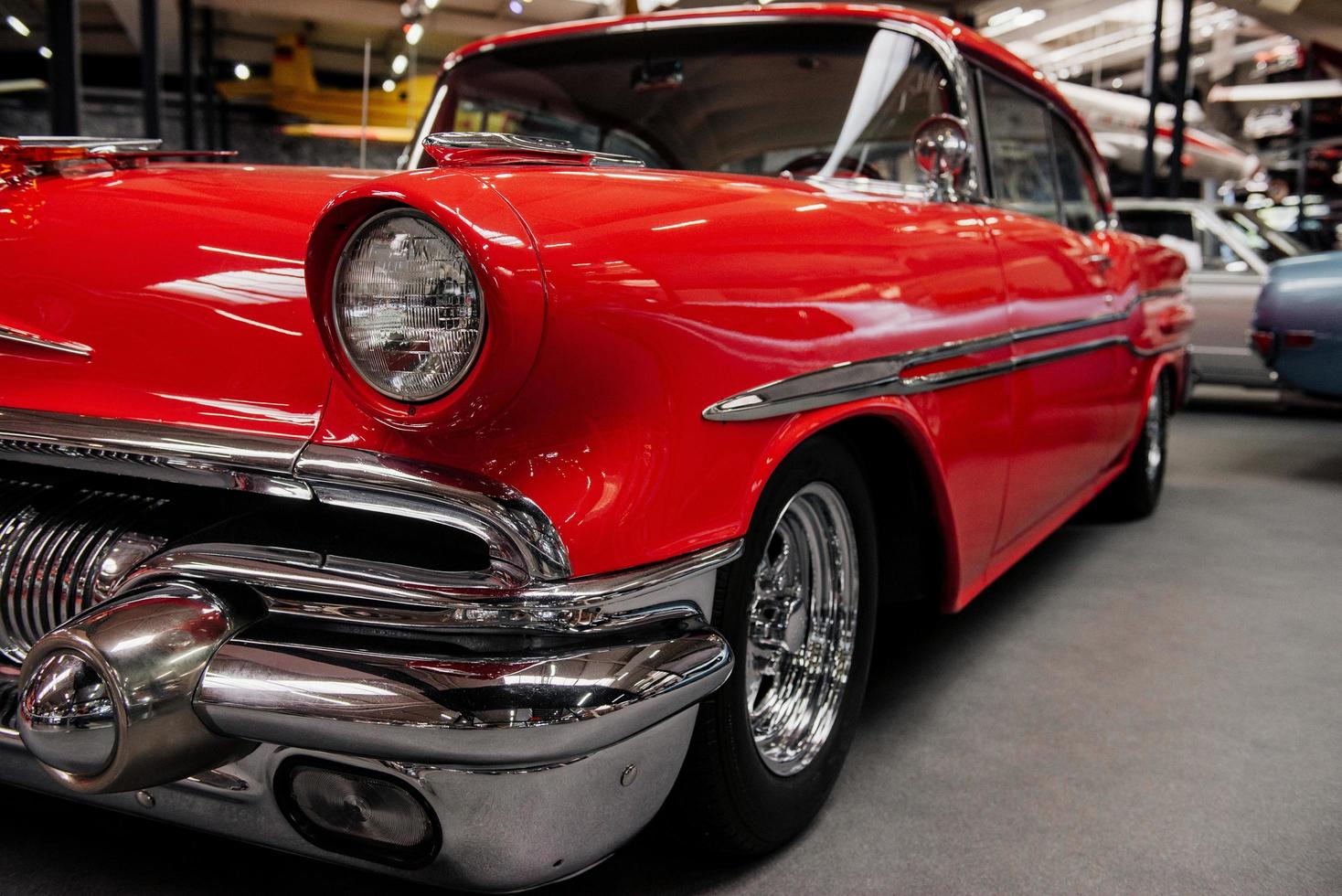 SINSHEIM, GERMANY - OCTOBER 16, 2018 Technik Museum. Look at these polished details. Stylish red car from the retro collection standing at vehicle exhibition photo