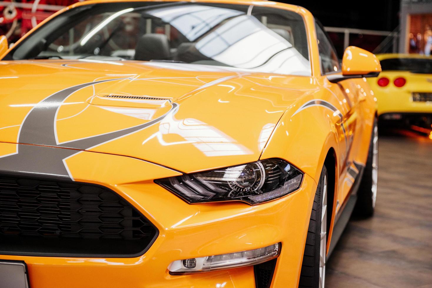 SINSHEIM, GERMANY - OCTOBER 16, 2018 Technik Museum. Perfect lighting. Gorgeous close up view of the front of luxury yellow automobile standing indoors photo