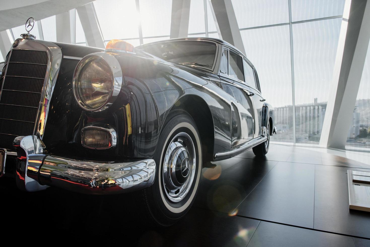 STUTTGART, GERMANY - OCTOBER 16, 2018 Mercedes Museum. Daylight going through the windows. Black polished retro car. Particle view photo