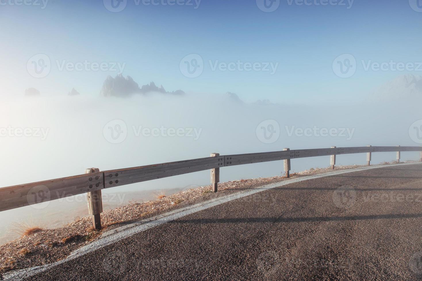 View of the mountains full of fog far from the road photo
