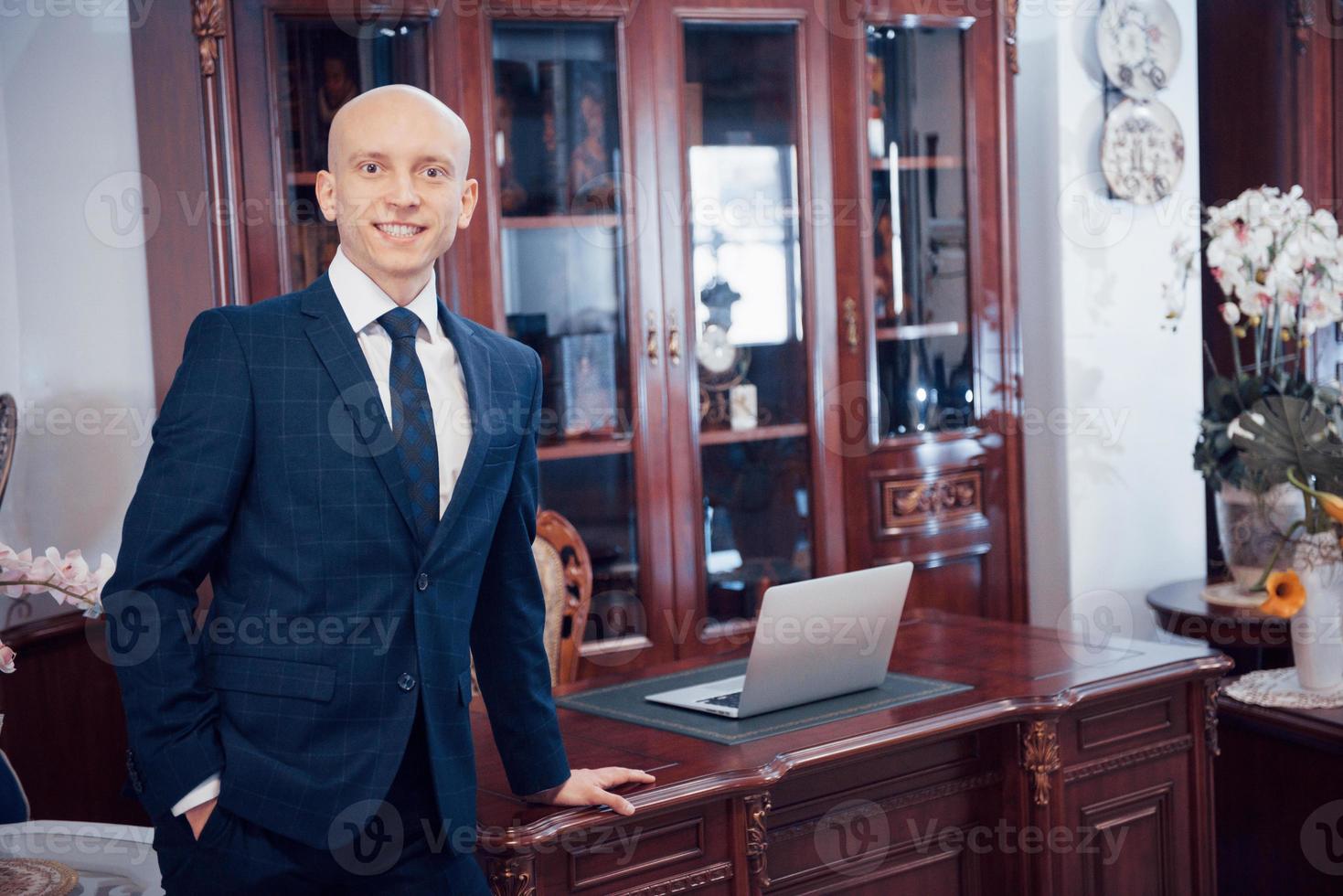 Confident handsome businessman sitting in luxury interior photo