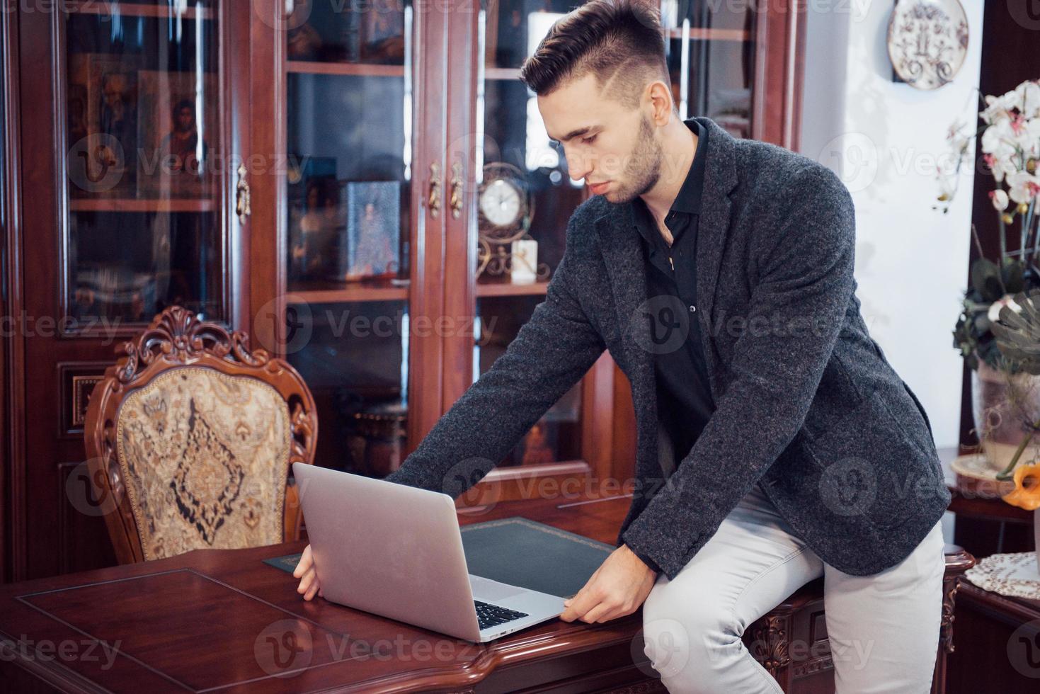 Confident handsome businessman sitting in luxury interior photo