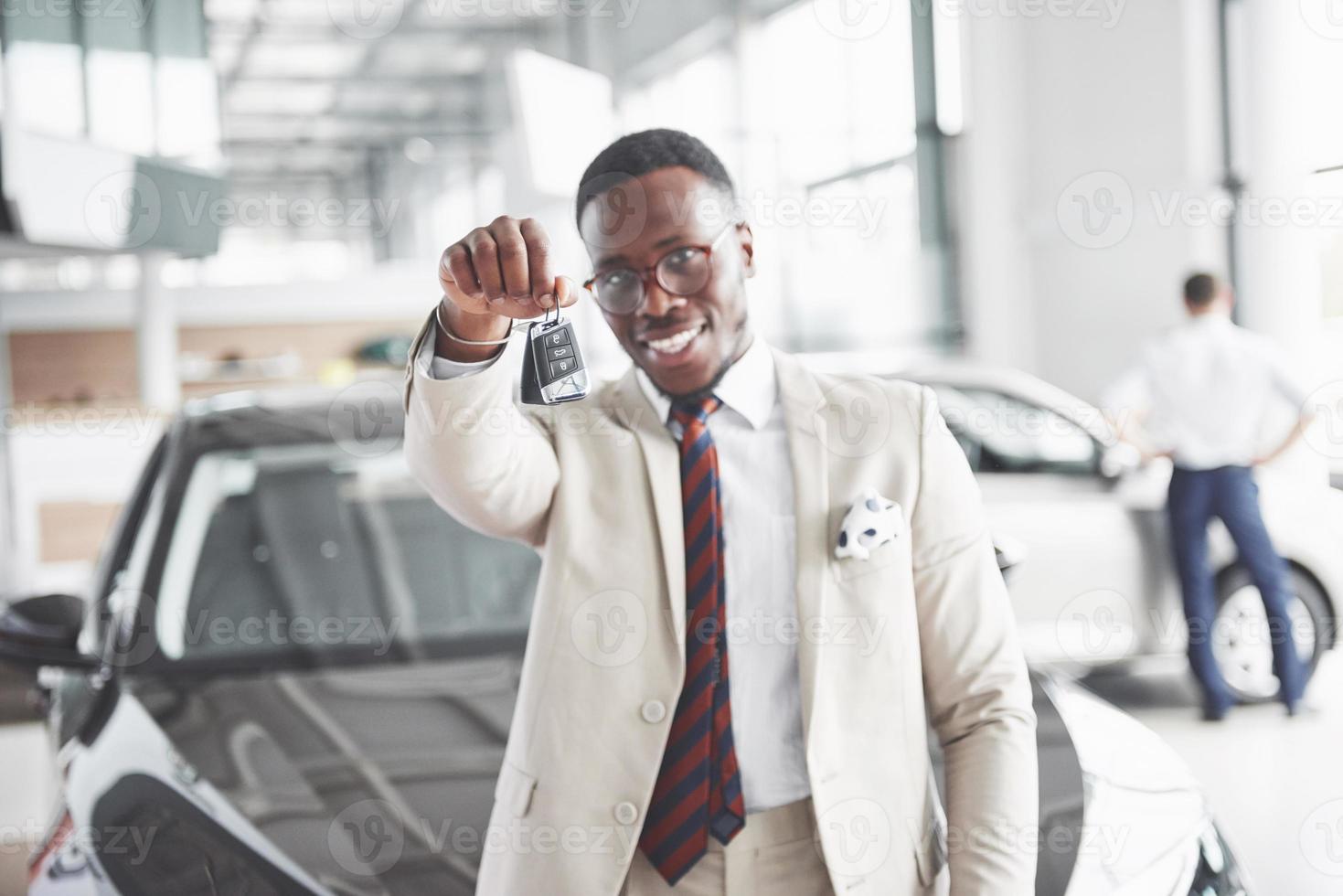 The young attractive black businessman buys a new car, dreams come true photo