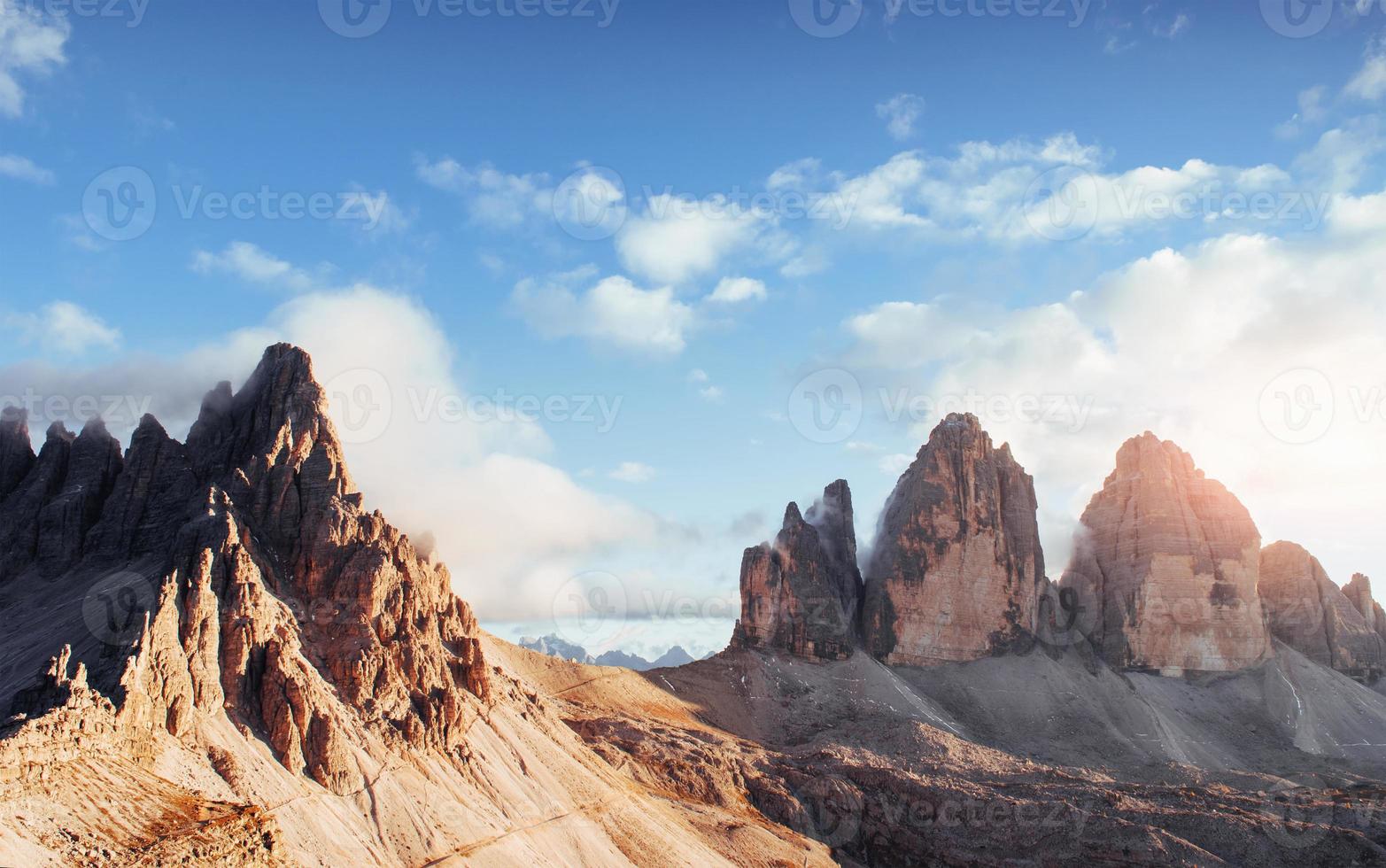 Great Paternkofel and Tre Chime mountains in one picture with fog on the top and cloudly sky photo