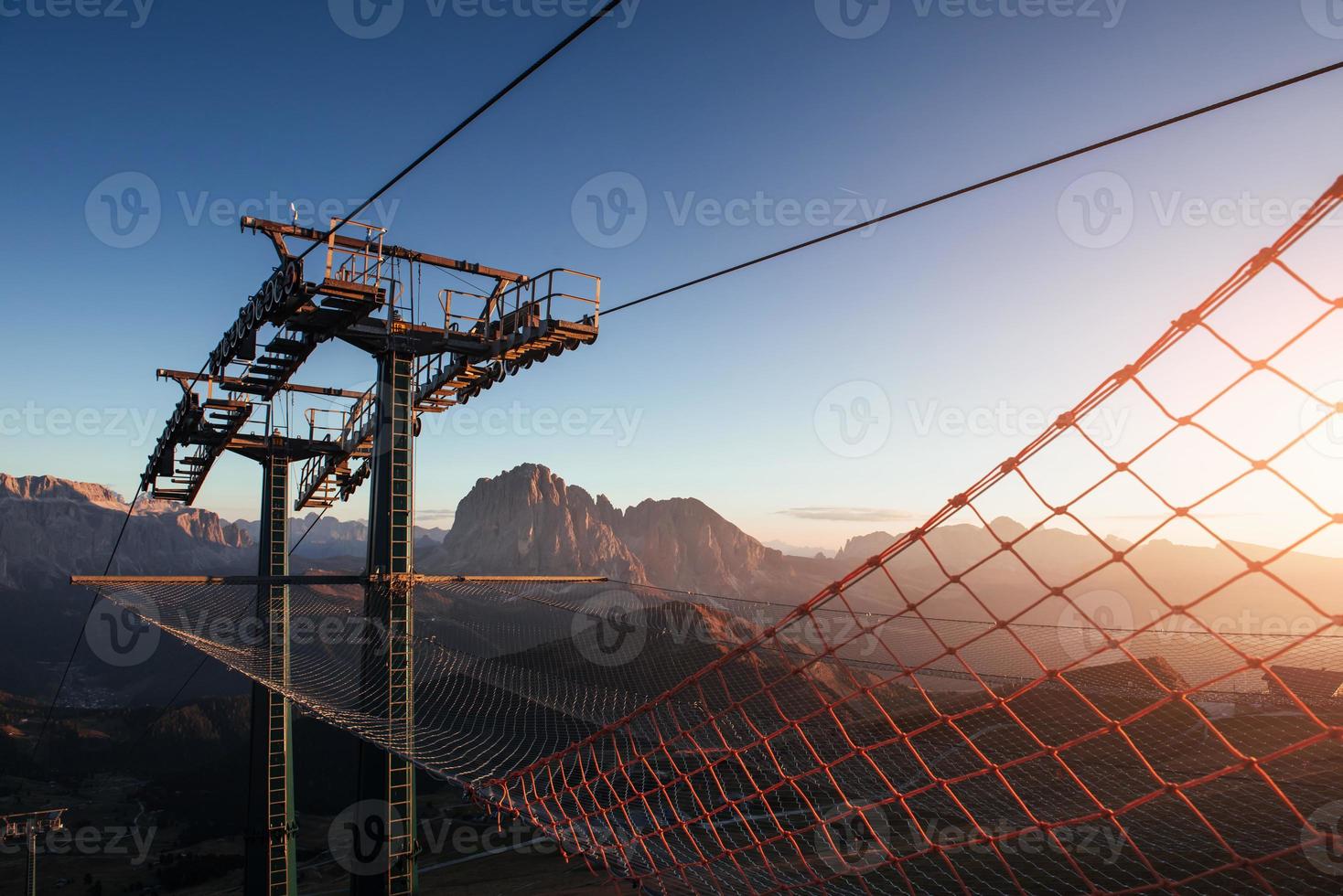 Sunlight going through the net. Cableway standing on the hills in Seceda dolomites photo