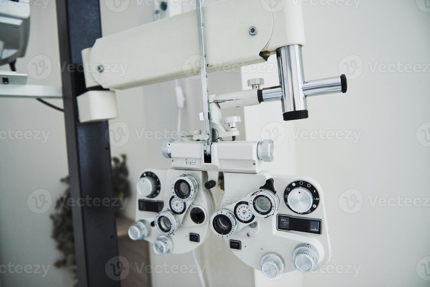 Photo of phoropter. Ophthalmologist devices in the beautiful white room