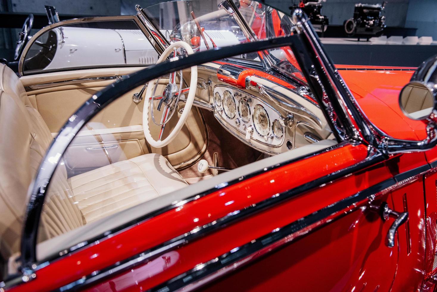 Into inside of the vintage red shiny car. It looks as though it's just from production photo
