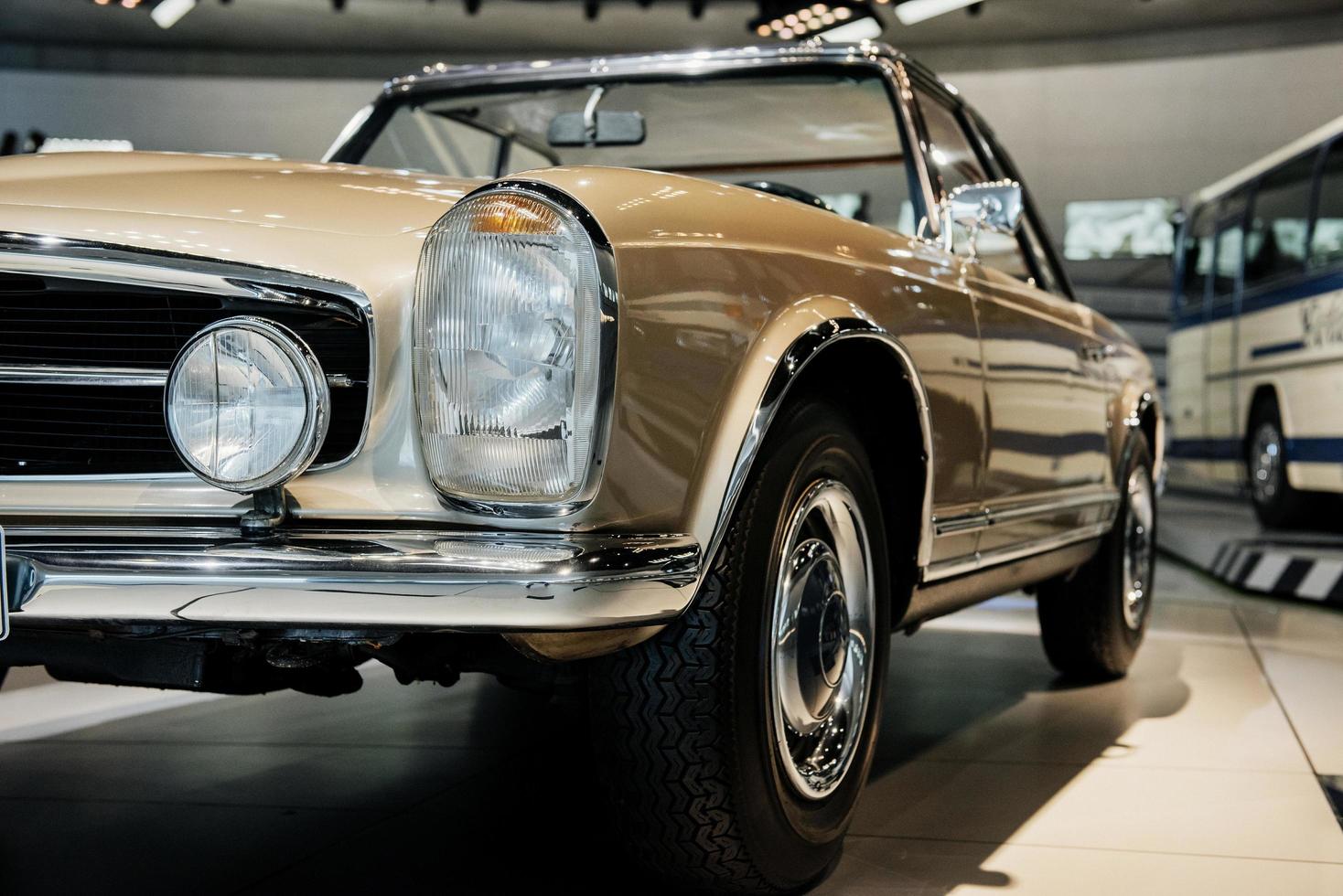 Photo of brown vintage polished and shiny car parked indoors