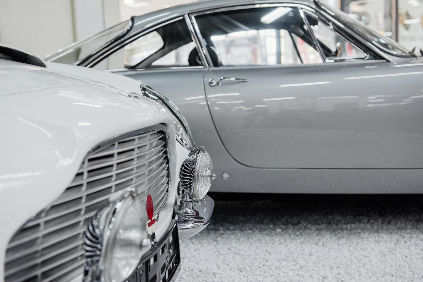 SINSHEIM, GERMANY - OCTOBER 16, 2018 Technik Museum. Silver automobile at background. Bumper and front headlights of good polished white vintage car photo