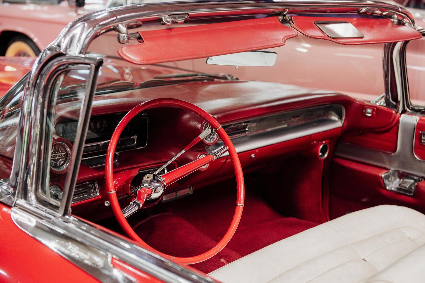 SINSHEIM, GERMANY - OCTOBER 16, 2018 Technik Museum. Inside of red vintage cabriolete. Speedometer and steering wheel photo