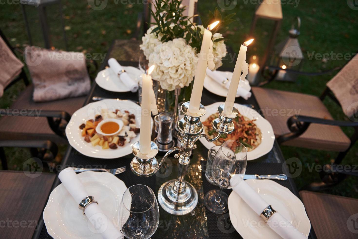 Close up top view of the served table with lighted candles and food photo