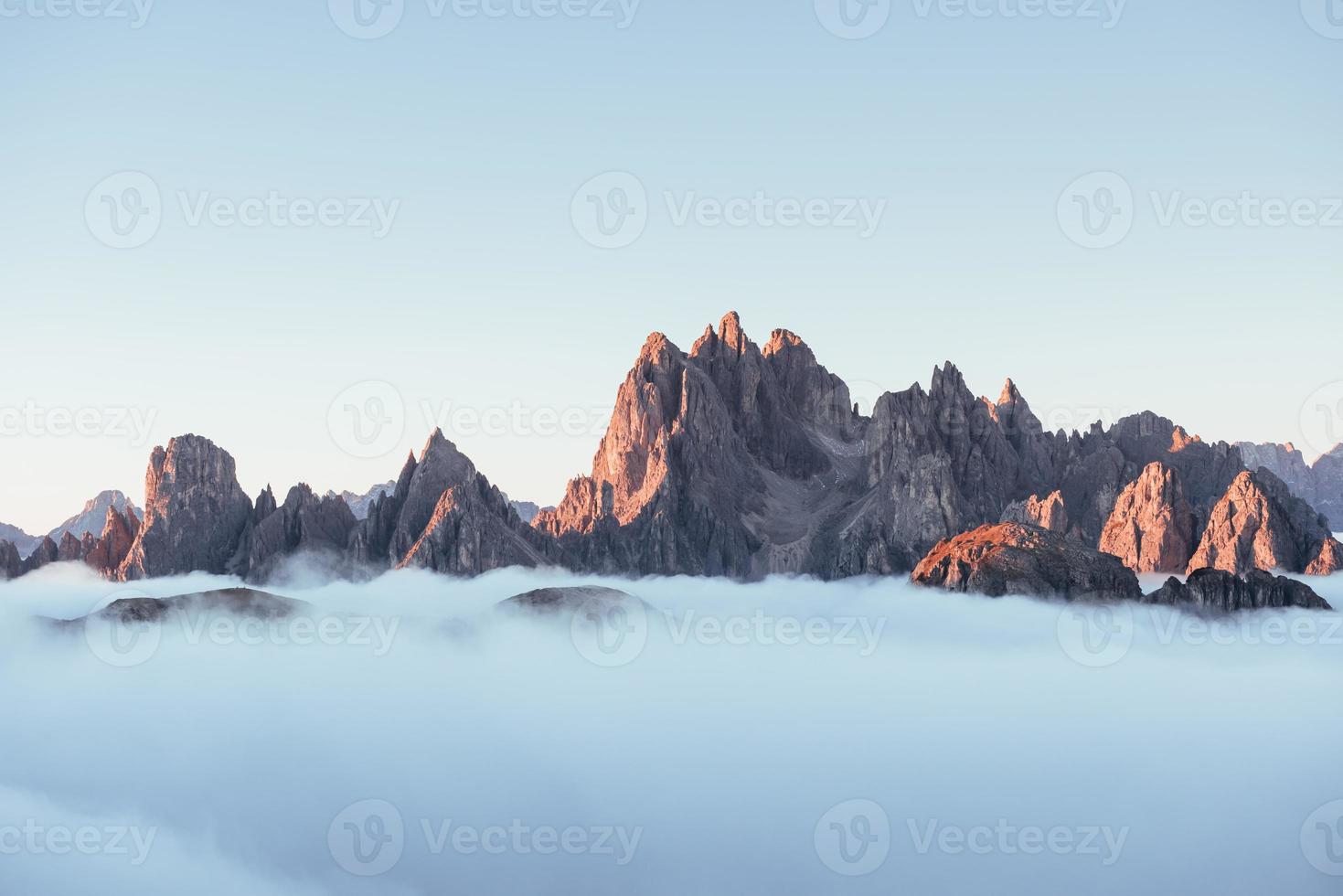 It's all bigger than you think. The peaks of the mountains stifle from a going thick fog. Unbelievable photo takes