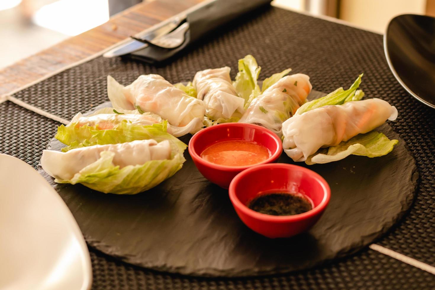 Vietnamese rolls with vegetables, served on restaurant photo