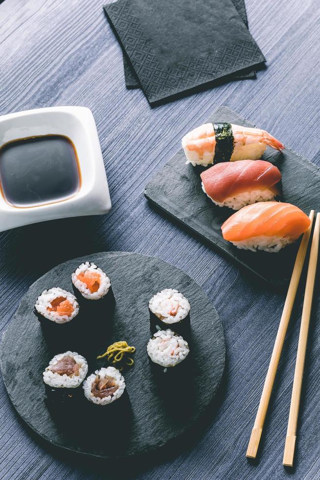 Sushi on wood table. Elegant japanese restaurant. Retro style photo