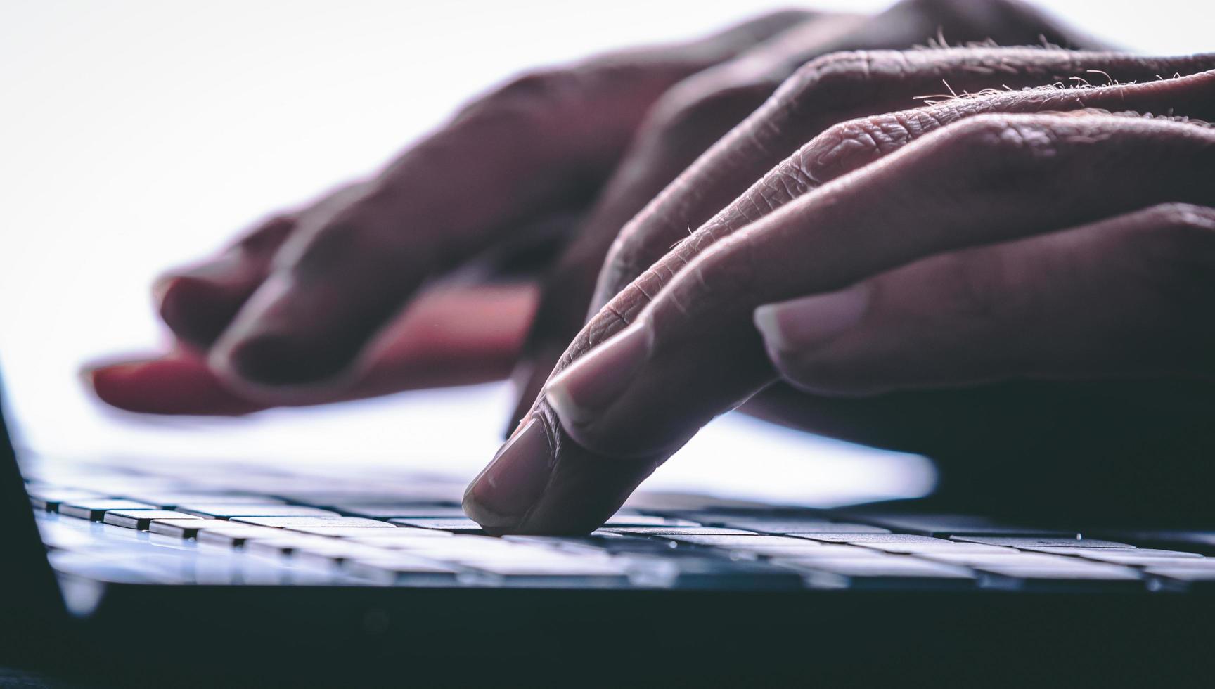 Hands typing on the computer keyboard. Modern style photo