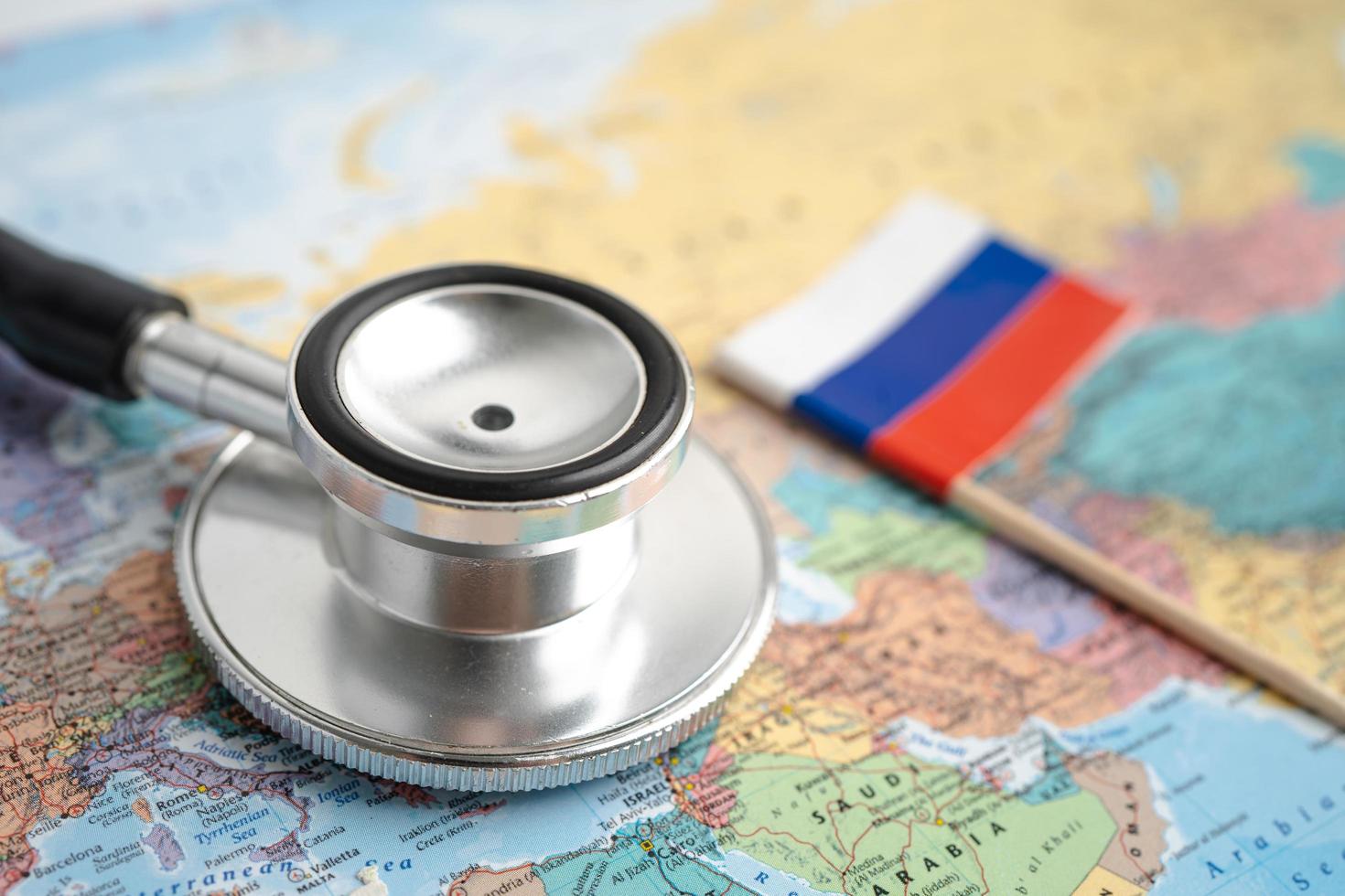 Bangkok, Thailand - June 1, 2021, Stethoscope on Russia world globe map background. photo