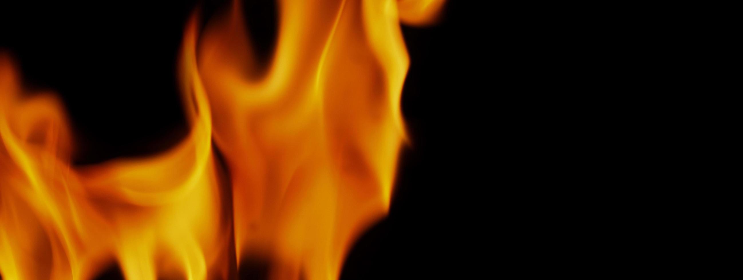 Fire background. Abstract burning flame and black background. photo