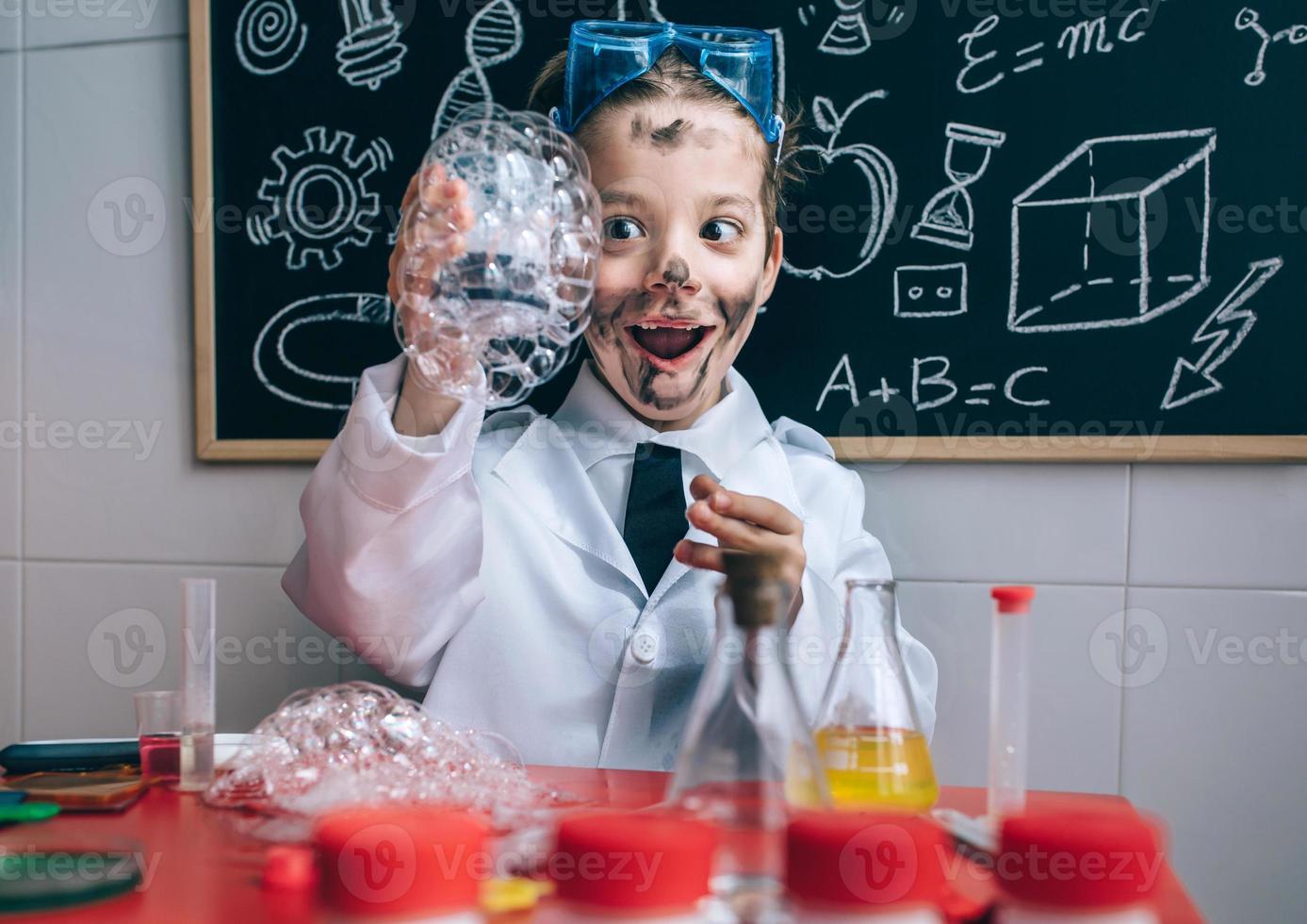 Happy hid holding glass with soap foam photo