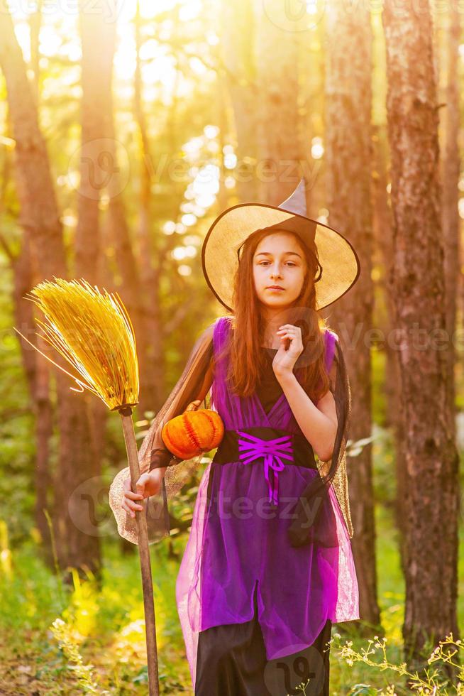 Girl 11 years old against the background of autumn nature. Little girl in Halloween costume, autumn. photo