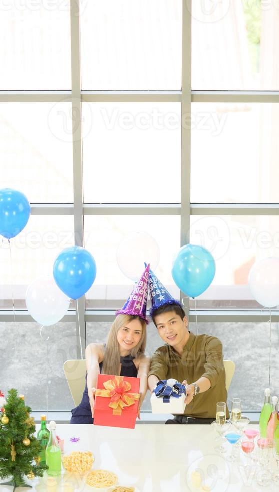 Young couple eat food and drinks on New Year's eve. photo