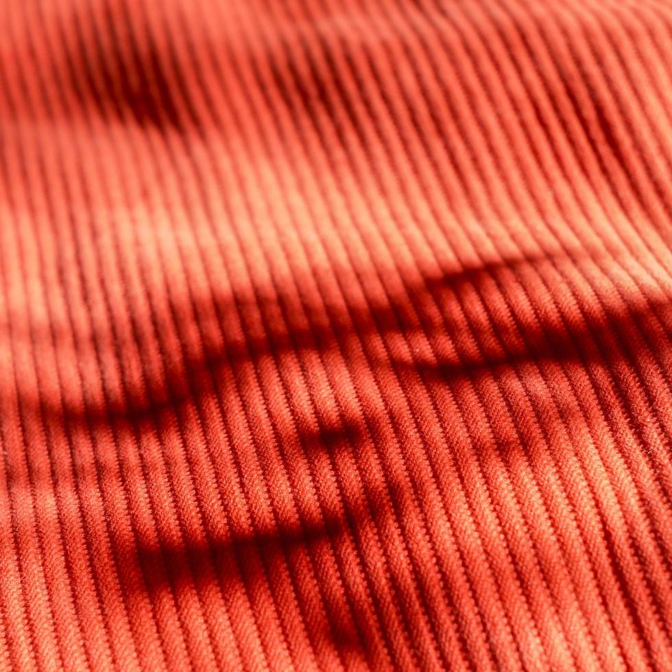 Red cloth background with hard shadows. Red drapery texture. photo