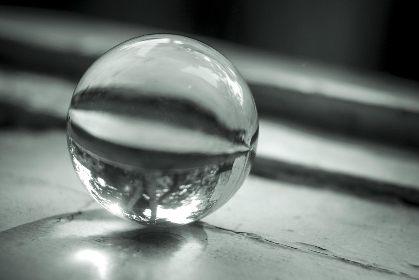 Monochrome image of a lens ball on an old window sill photo