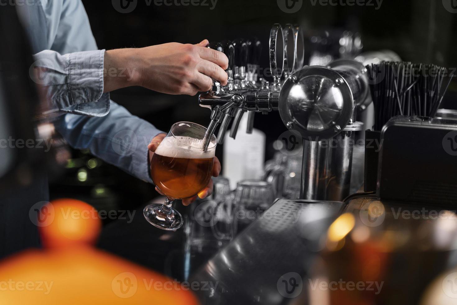 close up hand pouring beer glass. High quality beautiful photo concept
