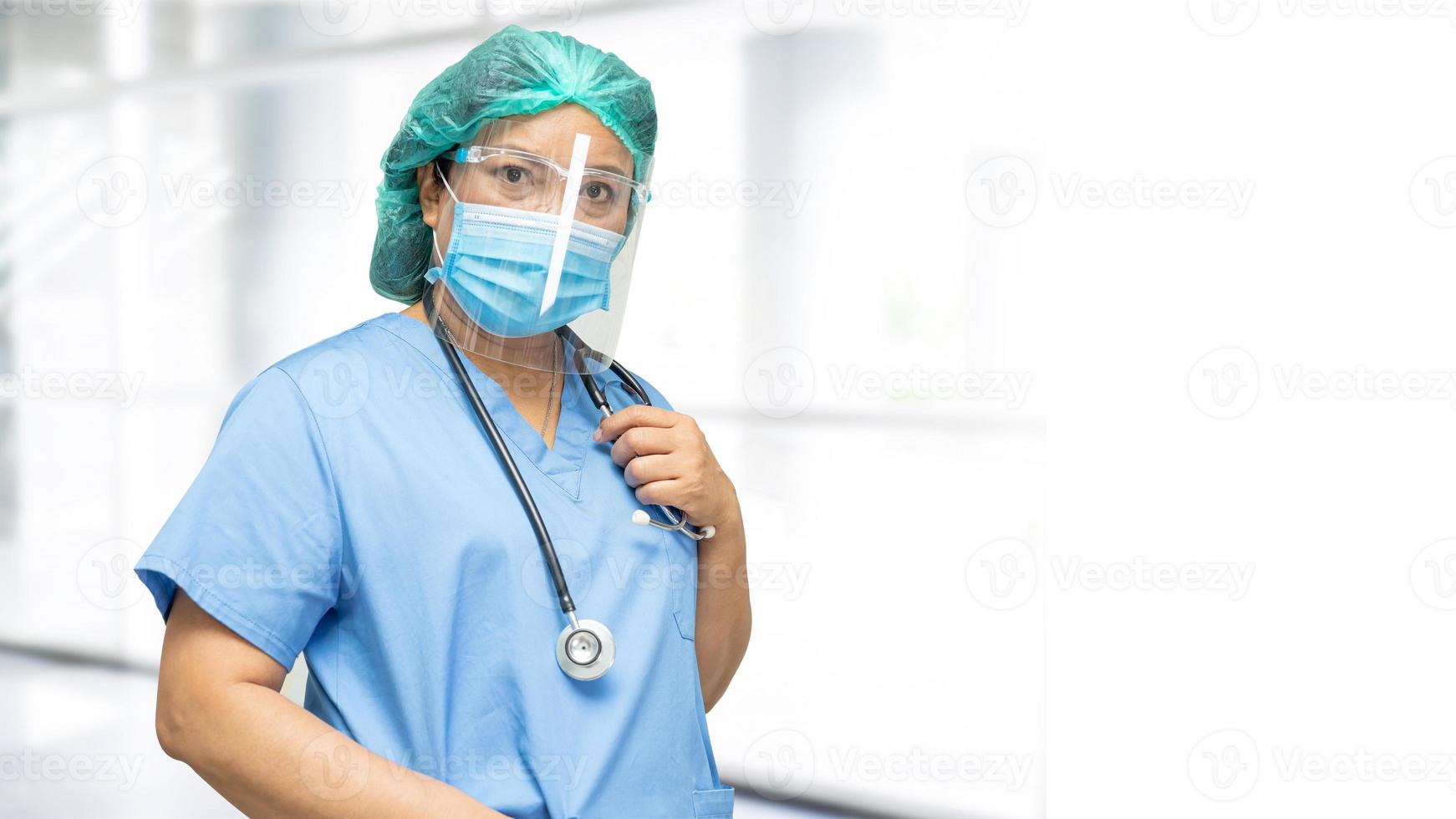 Asian doctor wearing face shield and PPE suit new normal to check patient protect safety infection Covid-19 Coronavirus outbreak at quarantine nursing hospital ward. photo