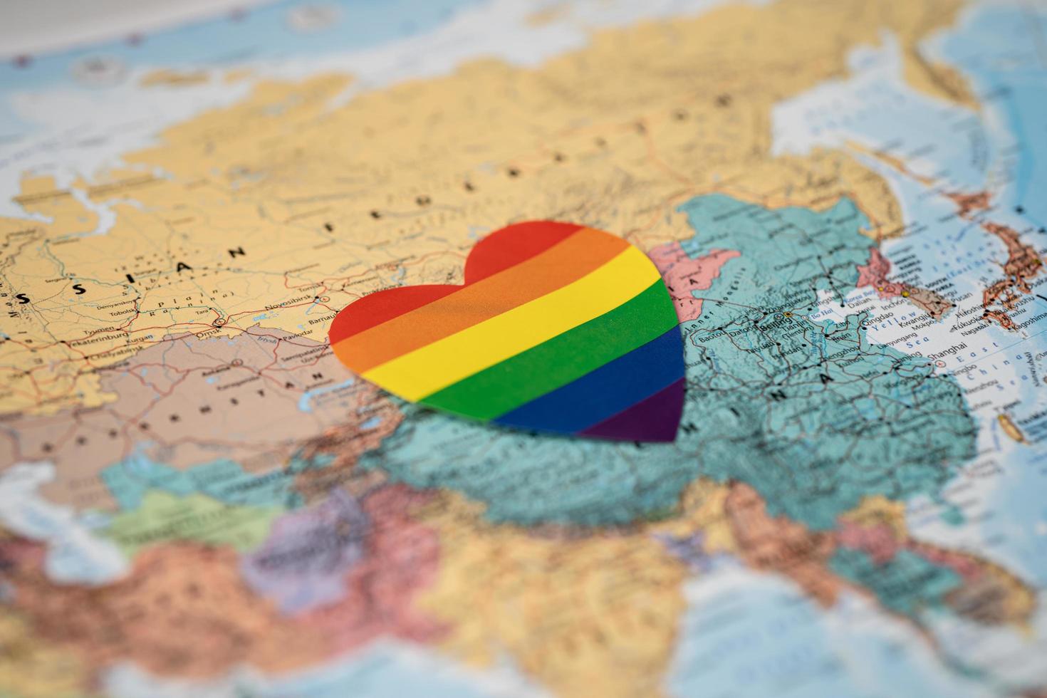 Rainbow color heart on Australia globe world map background, symbol of LGBT pride month  celebrate annual in June social, symbol of gay, lesbian, gay, bisexual, transgender, human rights and peace. photo