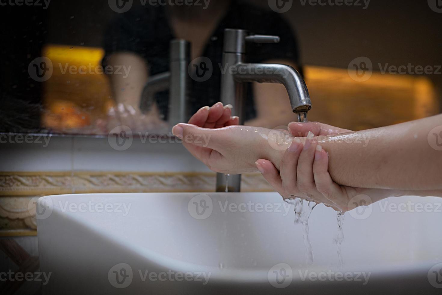 The beautiful female hand that applying soap in the sink from or anti-bacteria to prevent the spread of germs at white background photo