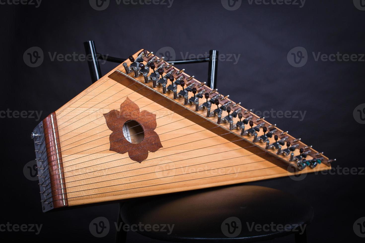 Russian folk musical instruments. Gusli isolated on a black background photo