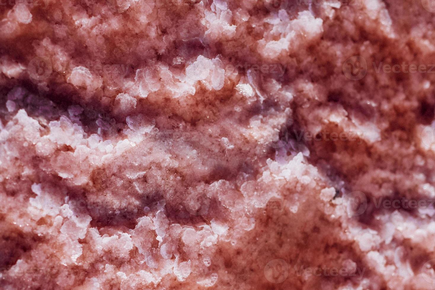 pink salt crystals on the pestle photo