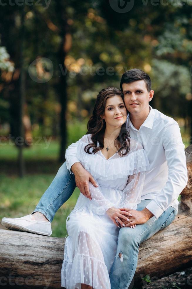 guy and a girl walk along the paths of a forest park photo