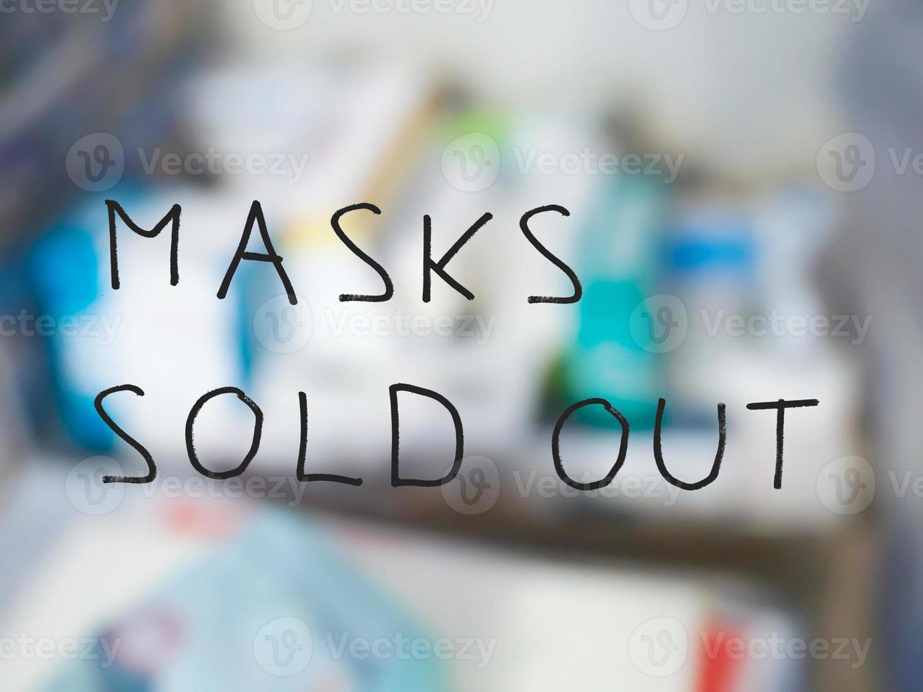 masks sold out sign, blurred pharmacy background photo